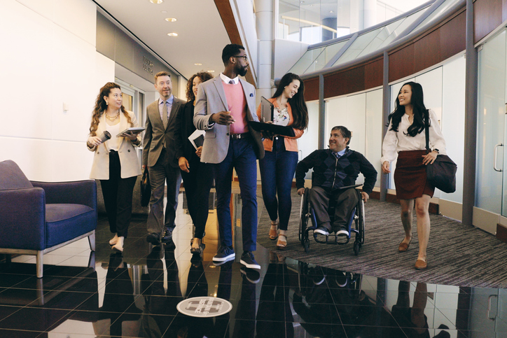 Diverse Business Team in an Office A diverse group of business people walking through an office.