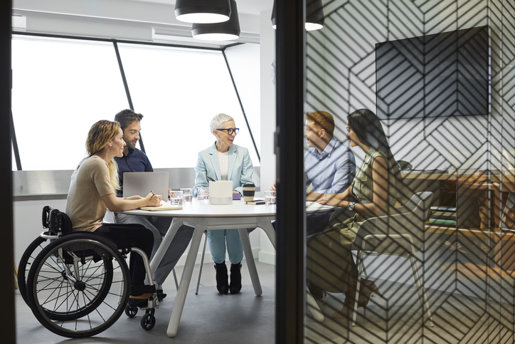 Business people discussing in office meeting Male and female professionals discussing in board room. Disabled businesswoman communicating with coworkers in meeting. They are at office.