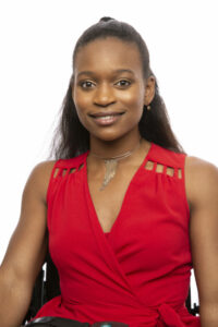 Woman looking at camera smiling wearing red dress