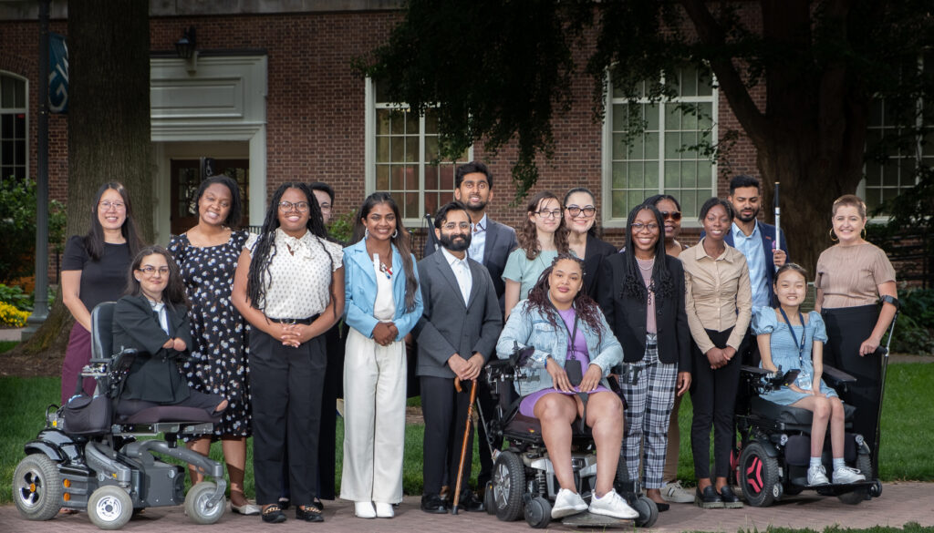 In-person 2023 AAPD summer interns wearing business casual and posing for a group photo on George Washington University's campus