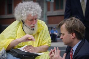 Bob Kafka, an older white man with white hair and a beard, in animated conversation with Mark McClellan, head of the agency that ran Medicaid and Medicare under the Bush administration