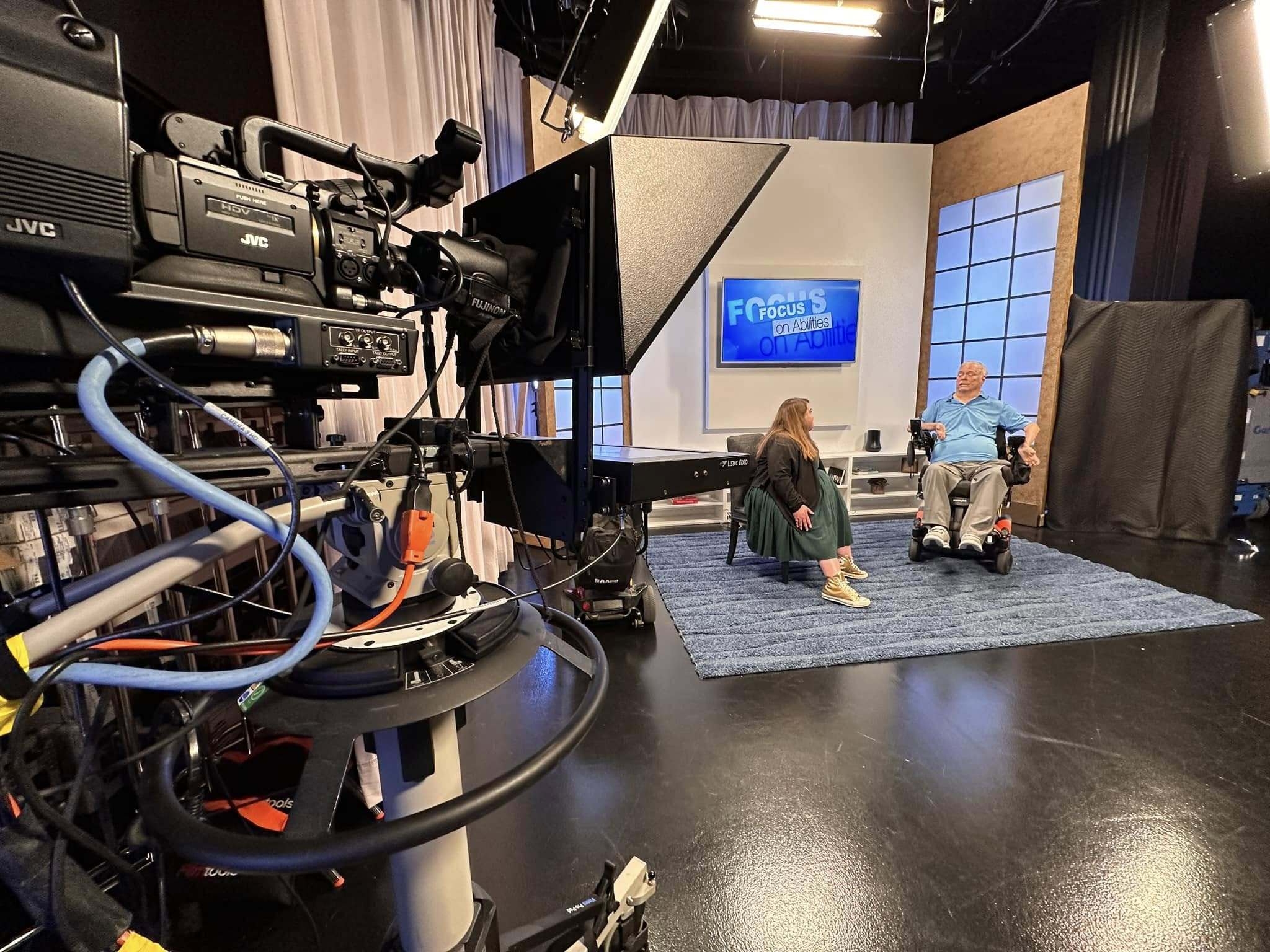 Maria Town and AAPD founder Lex Frieden on a television show set