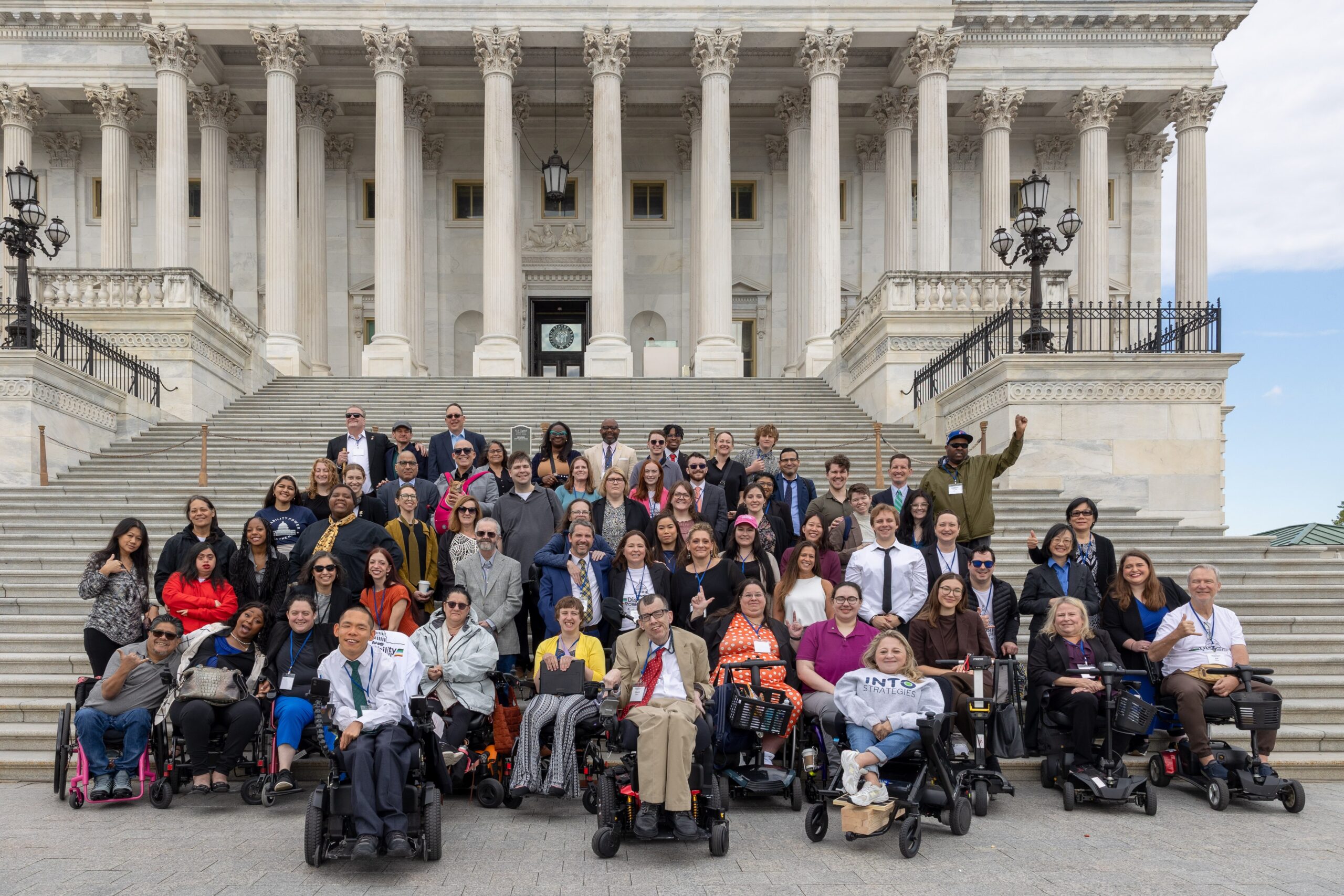 AAPD staff and advocates posing in front of the US Capitol building