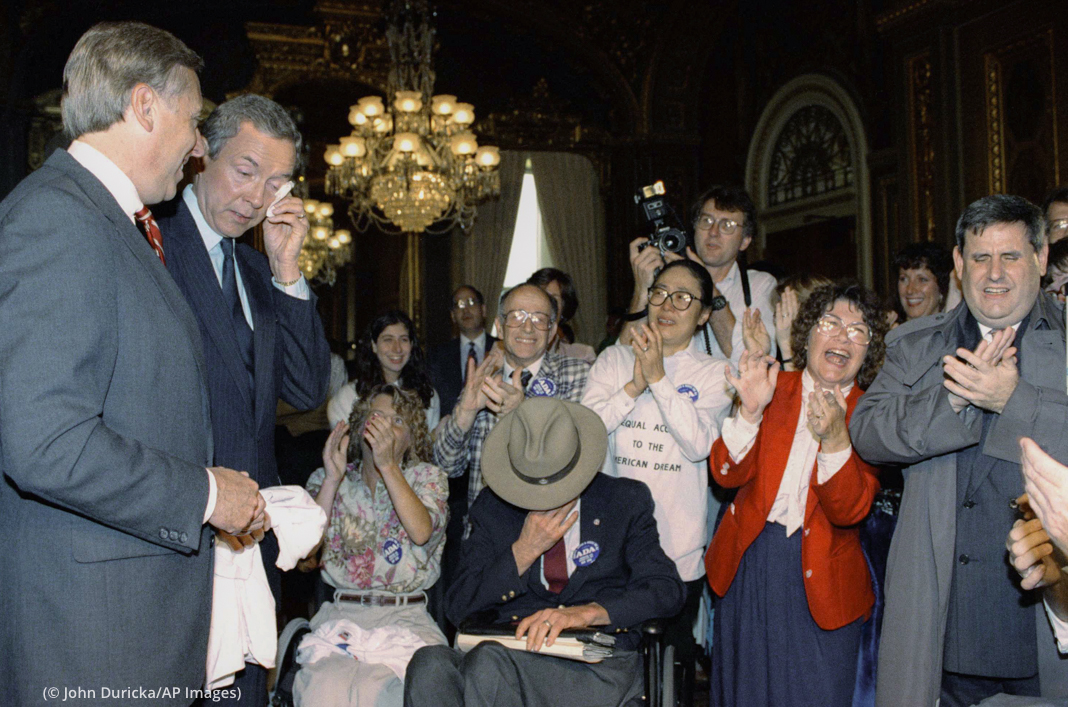 Rep. Steny H. Hoyer, D-Md., left; Sen. Orrin Hatch, wiping a tear of joy and Justin Dart, head of the Presidentís commission on employing people with disabilities, in cowboy hat, show their emotions while celebrating the passage of a bill guaranteeing a full range of civil rights for disabled Americans on Capitol Hill in Washington on Friday, July 13, 1990. The measure guarantees the nationís estimated 43 million disabled people access to jobs, transportation, stores, restaurants and other public accommodations.